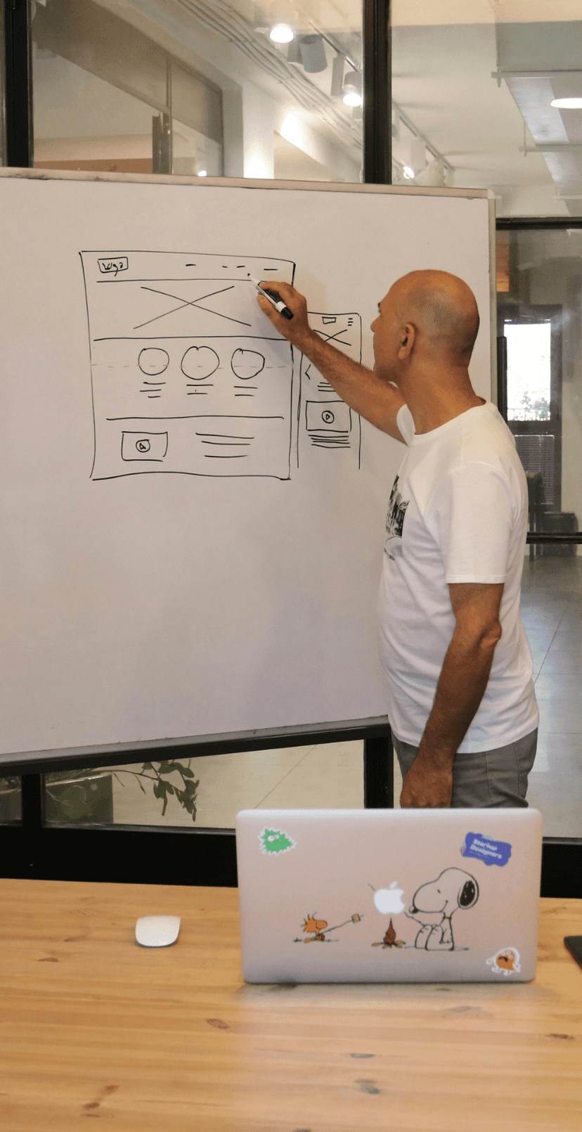 Person presenting UI design on whiteboard